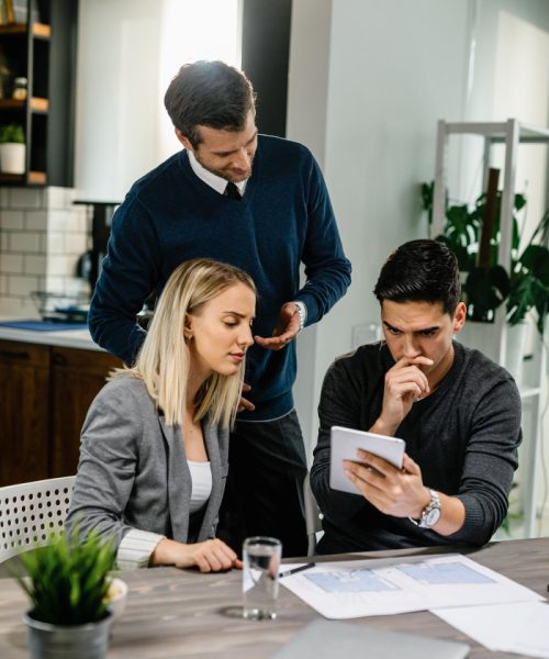 young-couple-feeling-uncertain-while-using-digital-tablet-meeting-with-their-insurance-agent-home (1)